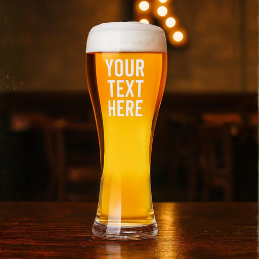 Personalized beer glass with 'Your Text Here' on a wooden table.