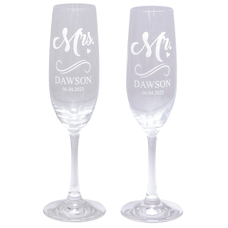 Two personalized champagne flutes with 'Mr.' and 'Mrs.' engraved on a white background.