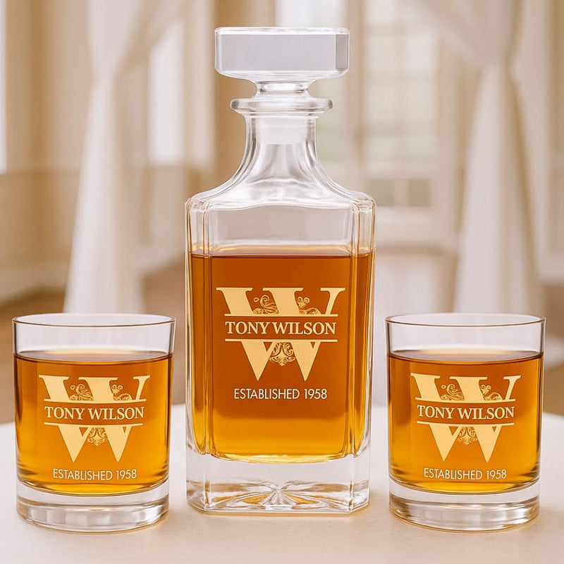 Personalized whiskey decanter and glasses with 'TONY WILSON' engraving on a neutral background.