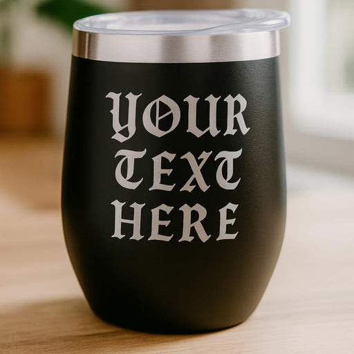 Black tumbler with 'Your Text Here' text on a wooden surface