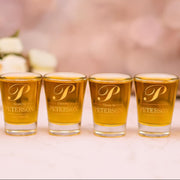Five shot glasses with 'P' logo and 'Peterson' text on a blurred background
