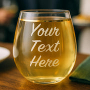 Personalized wine glass with 'Your Text Here' text on a wooden table.