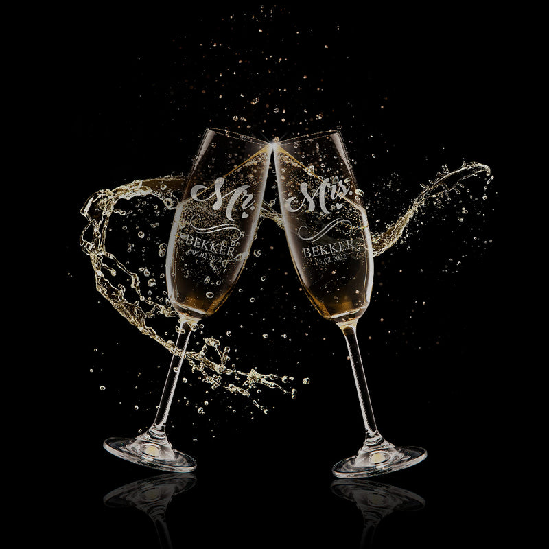 Two champagne glasses with 'Mr' and 'Mrs' engraving on a black background
