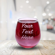 Red wine glass with 'Your Text Here' text on a wooden surface