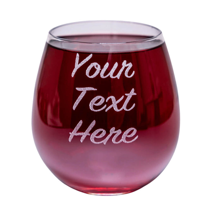 A stemless wine glass with custom text engraved on the side, filled with red wine.