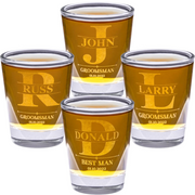 Set of personalized shot glasses with names and roles engraved on a white background