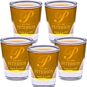 Set of five shot glasses with 'Peterson' engraving on a white background