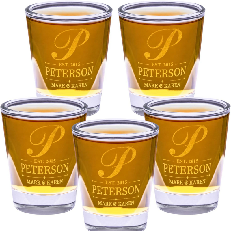 Set of five shot glasses with 'Peterson' engraving on a white background