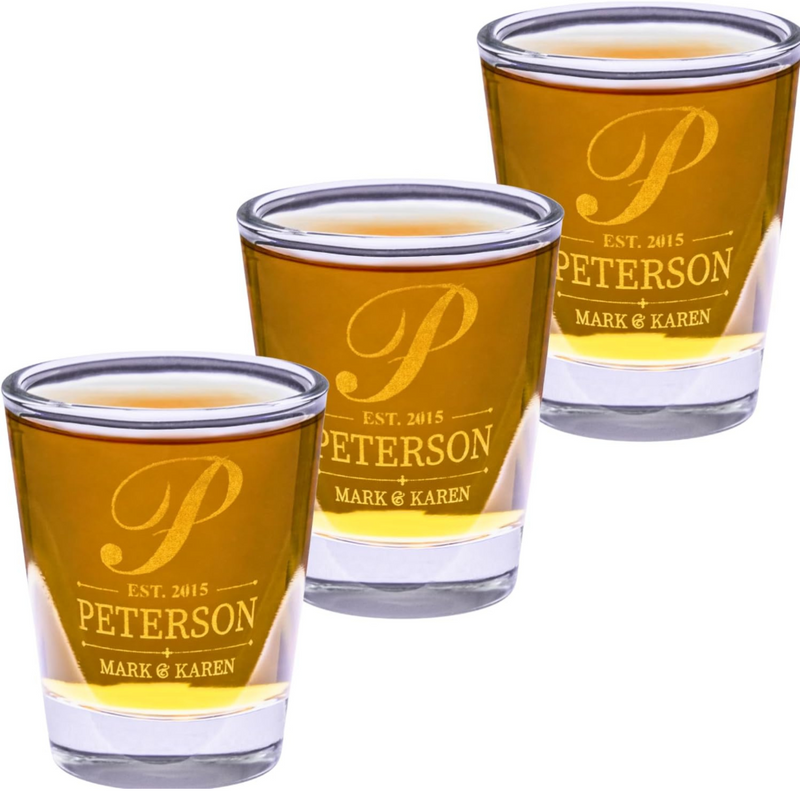 Three shot glasses with 'Peterson' engraving on a white background