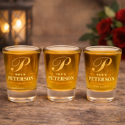 Three shot glasses with 'Pete Peterson' branding on a wooden surface.