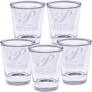 Set of five clear shot glasses with 'Peterson' branding on a white background