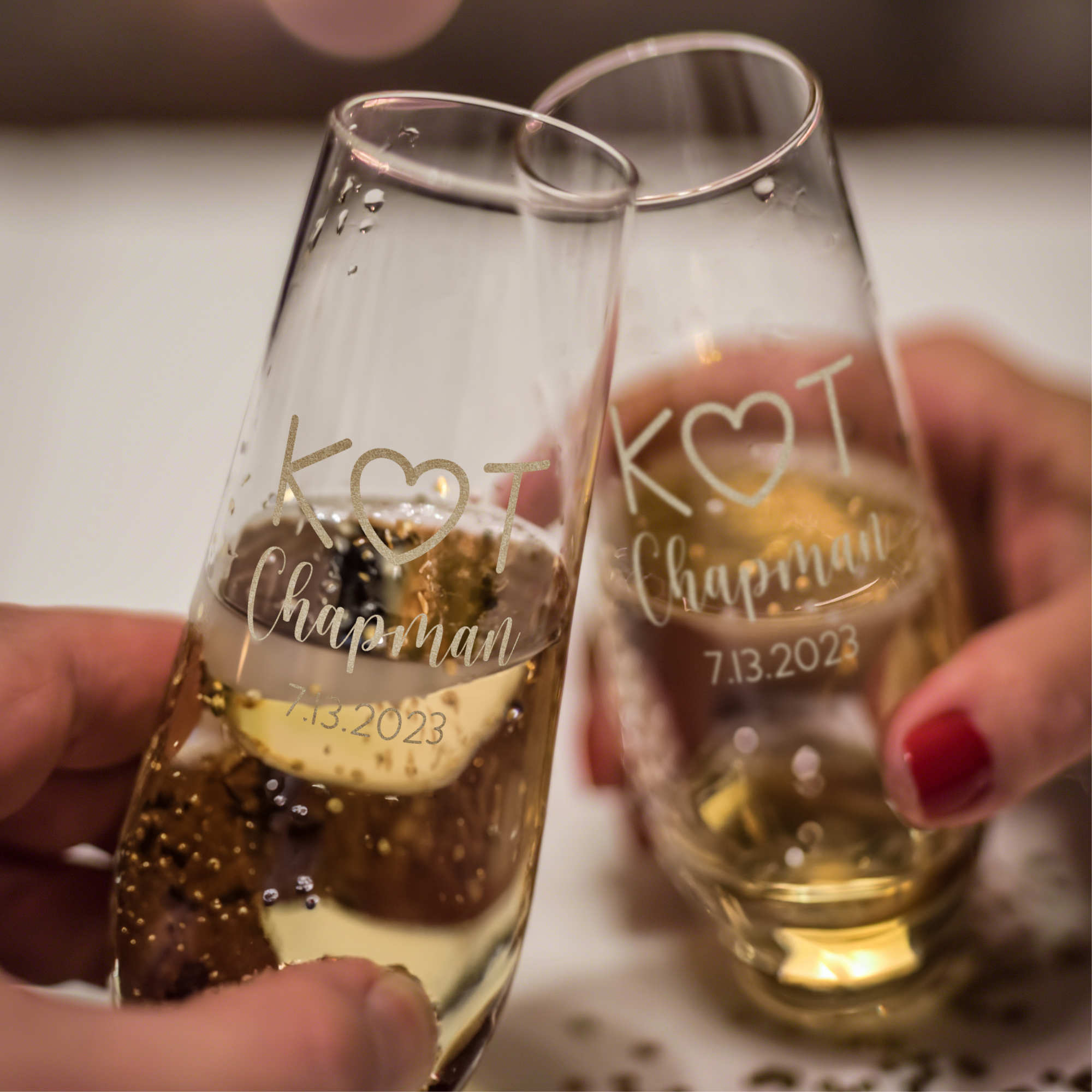https://giftsinscribed.com/wp-content/uploads/Cheering-toasting-stemless-champagne-glass-pair.png